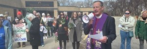 ​Hundreds gather for ecumenical Palm Sunday worship service, protest