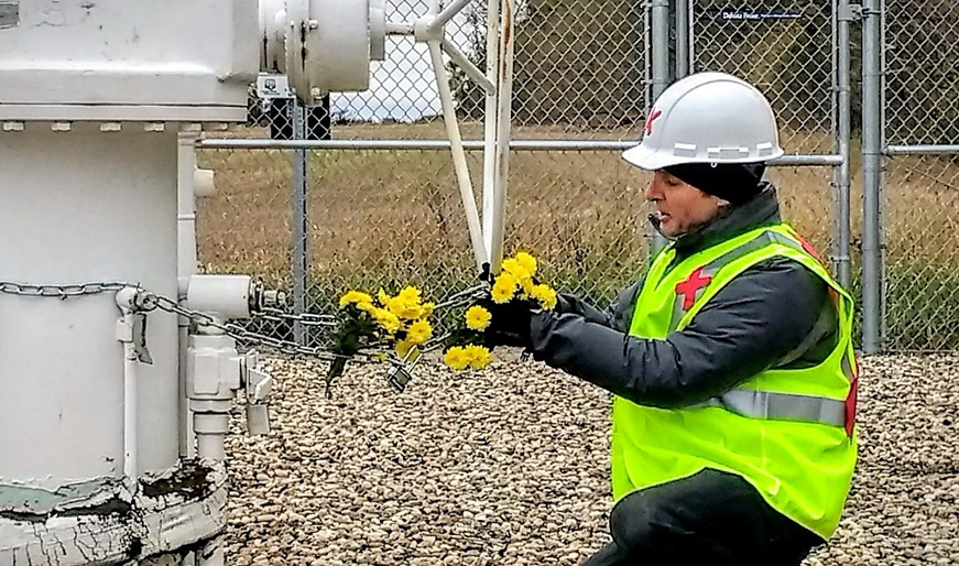 Michael Foster hanging yellow chrysnathemums along his own chain securing the Keystone Pipeline valve - photo provided by John Foster