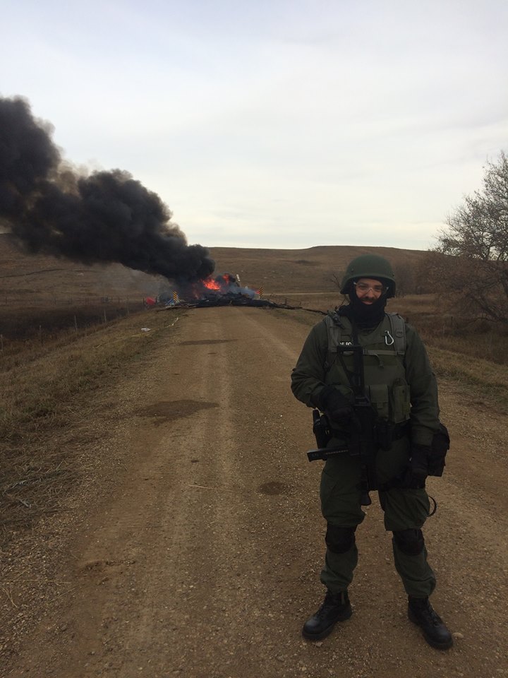 Posing for a picture at a barricade - that was not set on fire by activists, according to activists - online srouces