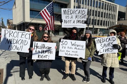 Protestors say “Let them eat cake” in Fargo on April 26
