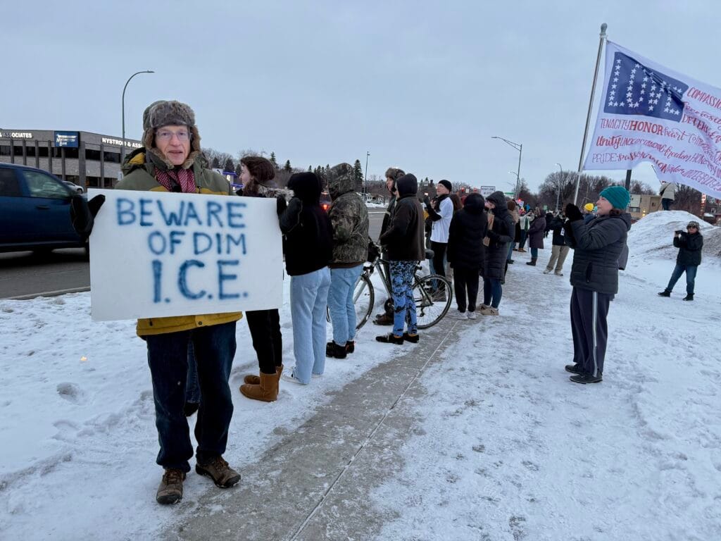 Protestors in Moorhead, Minnesota hold signs against ICE presence in the state